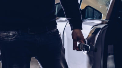 A person opens the door of a car