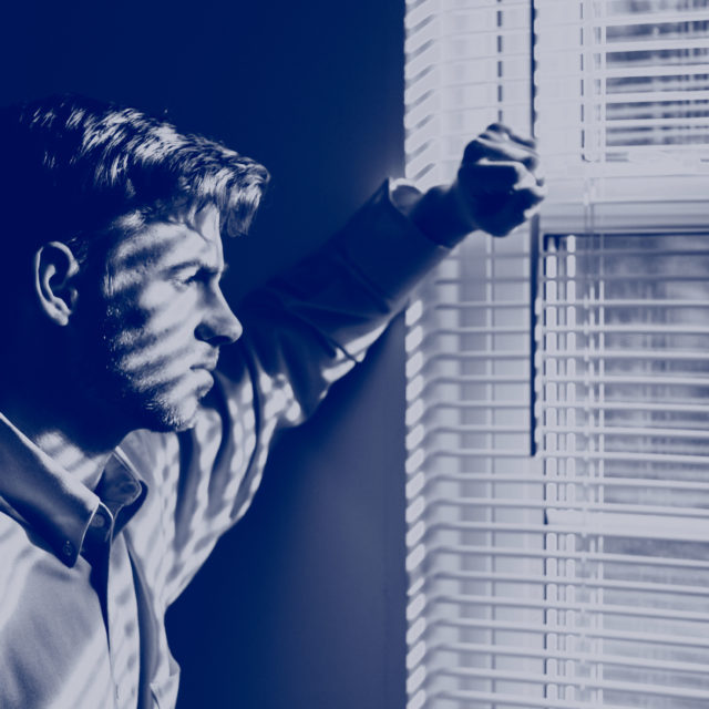 Man looks out a window