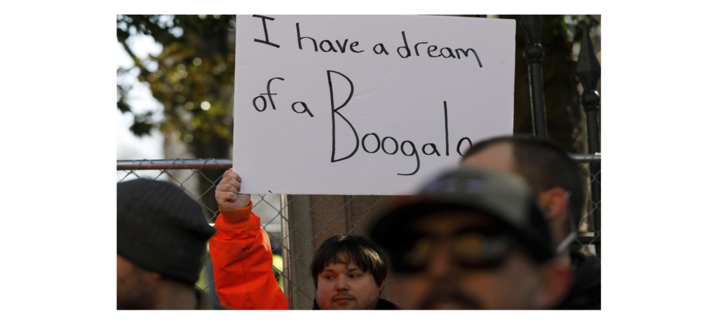 A man holds up a sign that says I have a dream of a Boogaloo