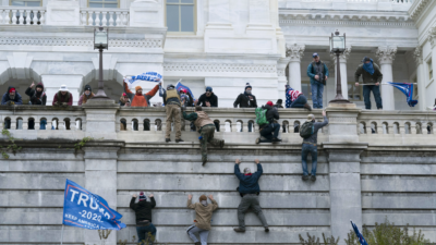 Protesters seen all over Capitol building where pro-Trump supporters riot and breached the Capitol in Washington, DC on January 6, 2021. Rioters broke windows and breached the Capitol building in an attempt to overthrow the results of the 2020 election. Police used buttons and tear gas grenades to eventually disperse the crowd. Rioters used metal bars and tear gas as well against the police.
